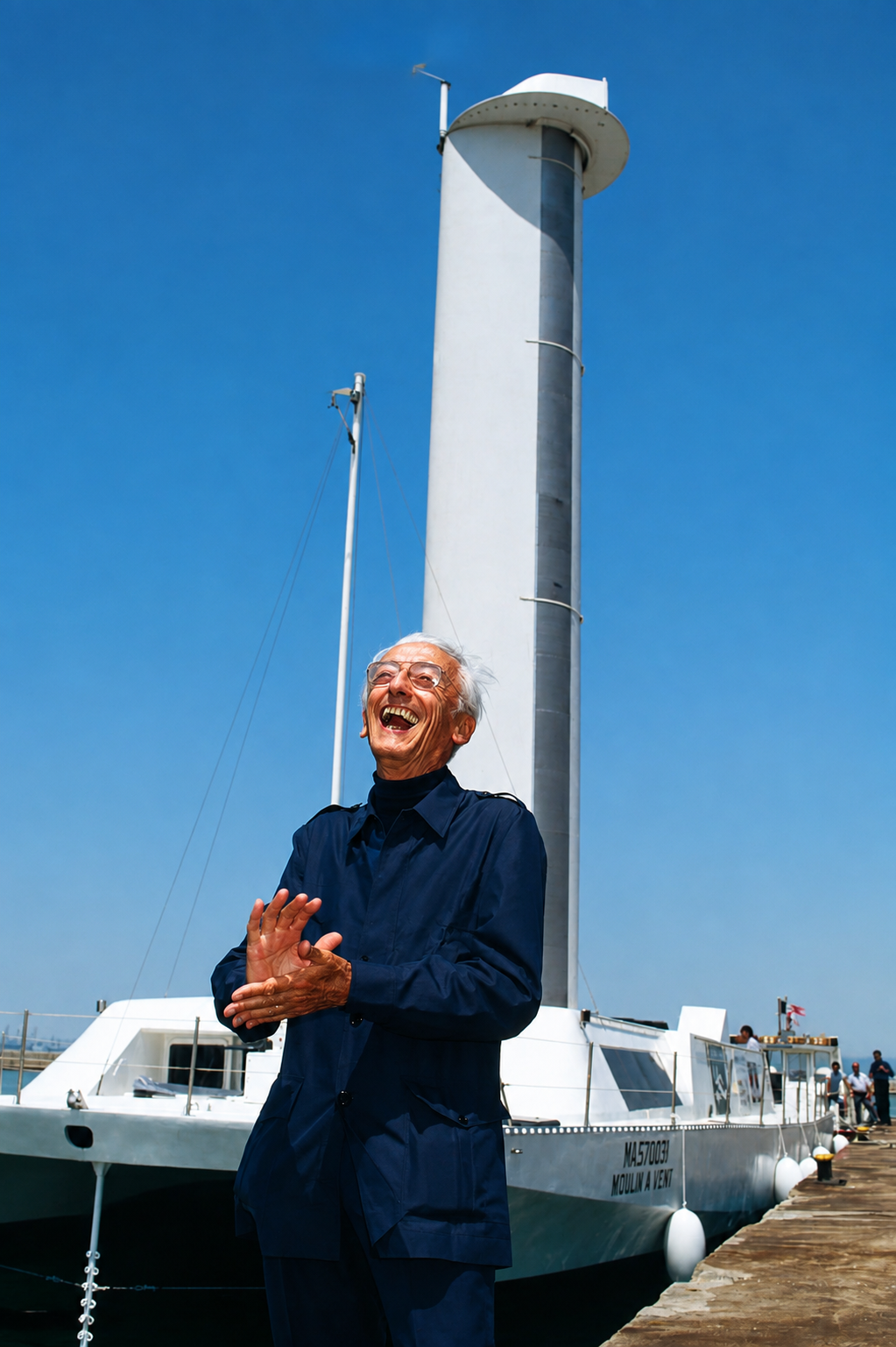 Jacques-Yves Cousteau standing before Moulin à Vent and its Turbosail